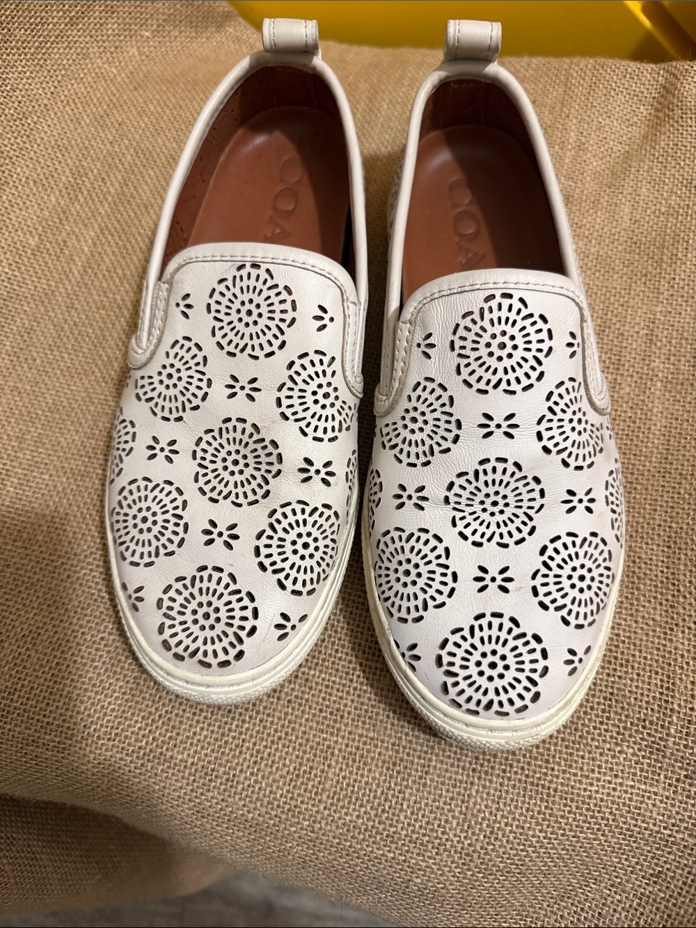 Coach Off White Leather Perforated Floral Slip-On Sneakers clip charms on back